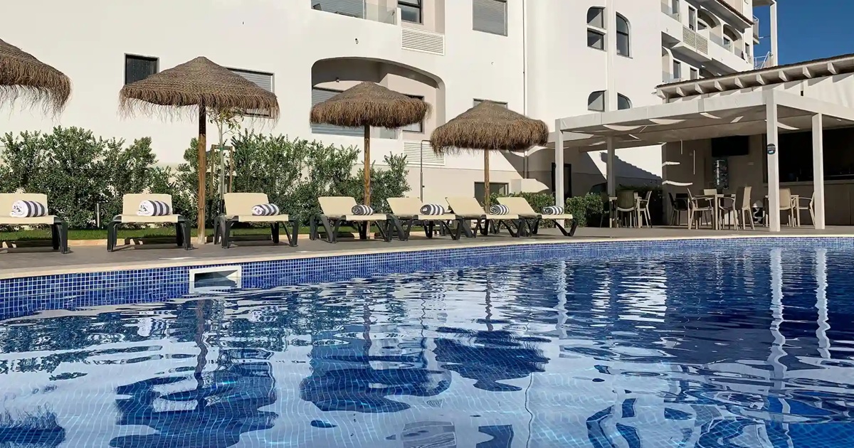 Outdoor pool and lawn at Água Hotels Alvor Jardim, Alvor