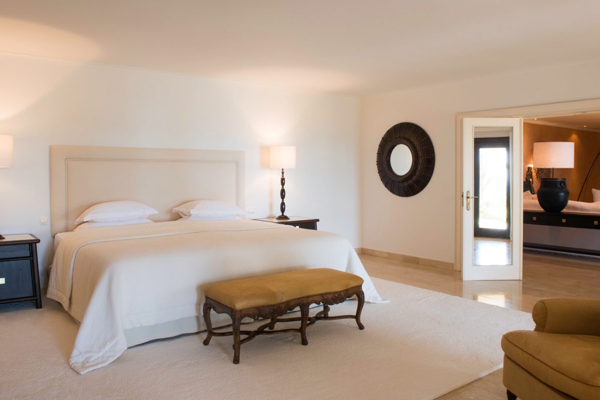 Suite bedroom at Vila Joya with cream linens and mustard accents