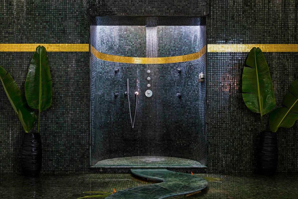 Walk-in rainfall shower with green tiles at Vila Joya